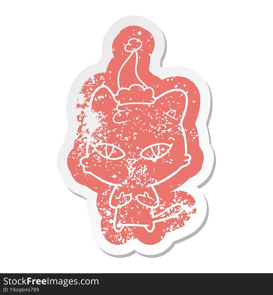 quirky cartoon distressed sticker of a cat wearing santa hat