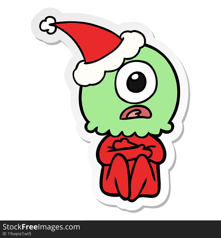 hand drawn sticker cartoon of a cyclops alien spaceman wearing santa hat