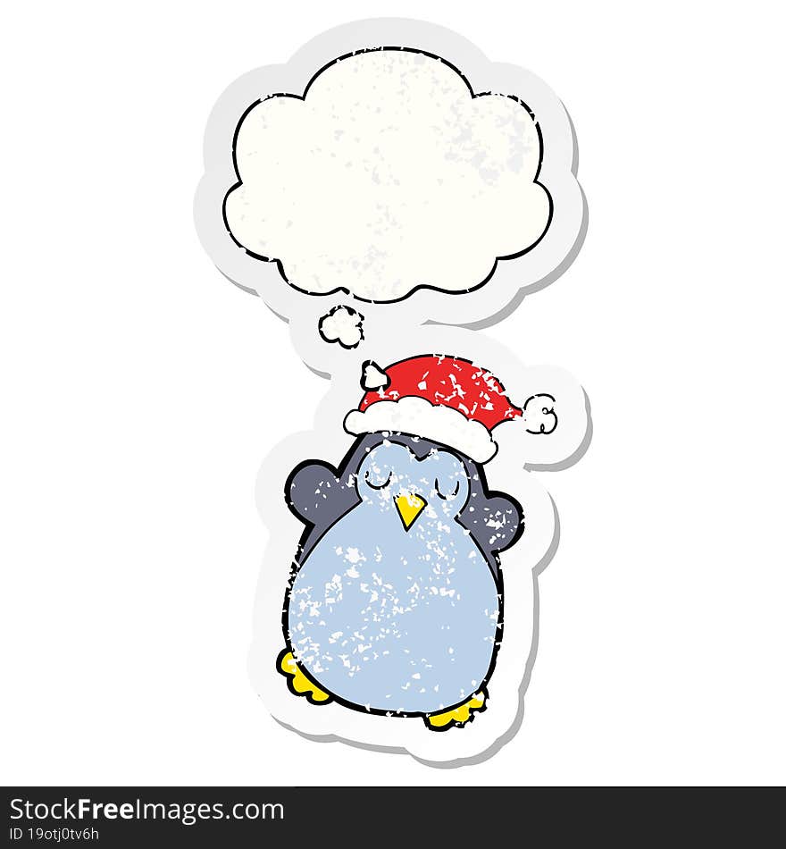 cute christmas penguin and thought bubble as a distressed worn sticker