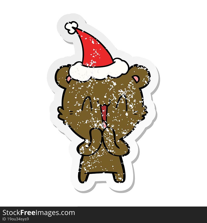 happy bear distressed sticker cartoon of a wearing santa hat