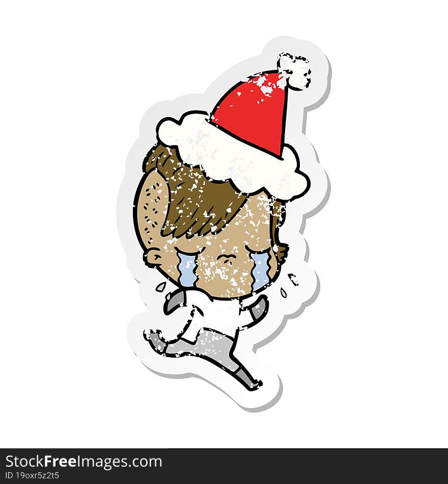 Distressed Sticker Cartoon Of A Crying Girl Wearing Space Clothes Wearing Santa Hat