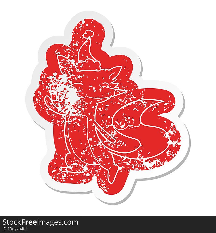 cartoon distressed sticker of a happy fox wearing santa hat