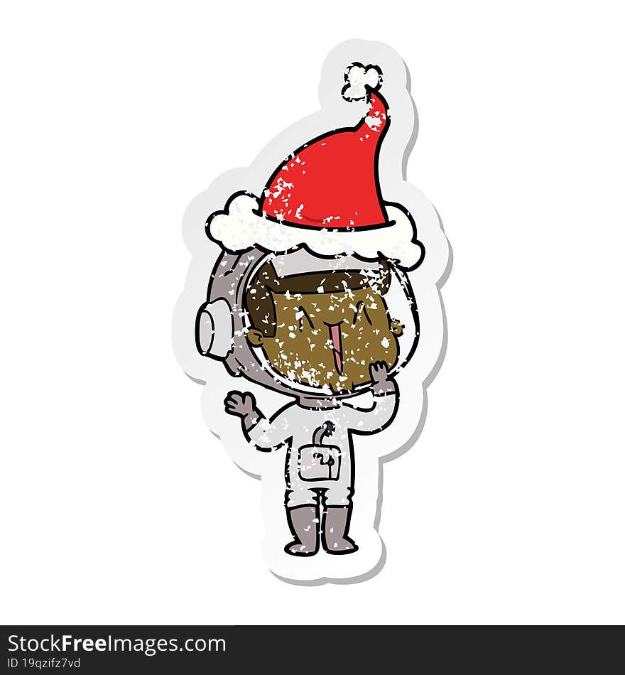 laughing hand drawn distressed sticker cartoon of a astronaut wearing santa hat