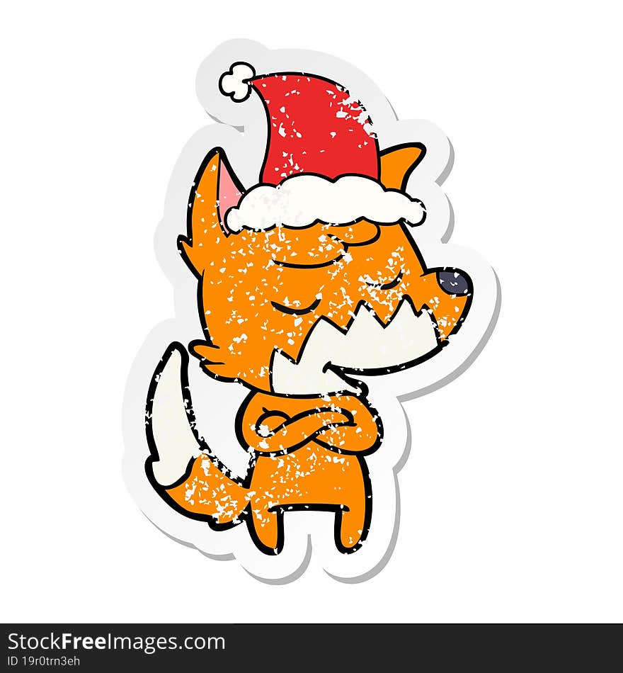 friendly distressed sticker cartoon of a fox wearing santa hat