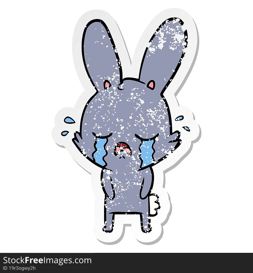 distressed sticker of a cute cartoon rabbit crying