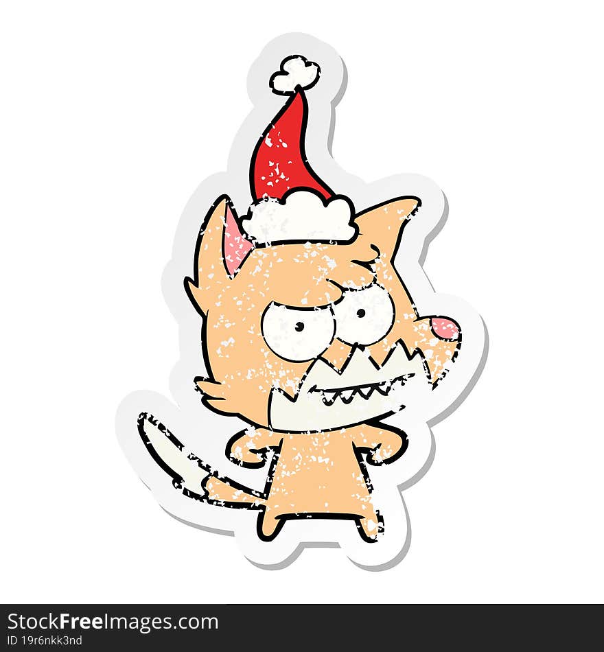 distressed sticker cartoon of a grinning fox wearing santa hat