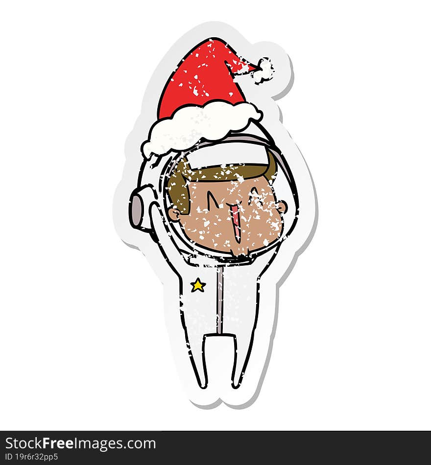 happy distressed sticker cartoon of a astronaut wearing santa hat