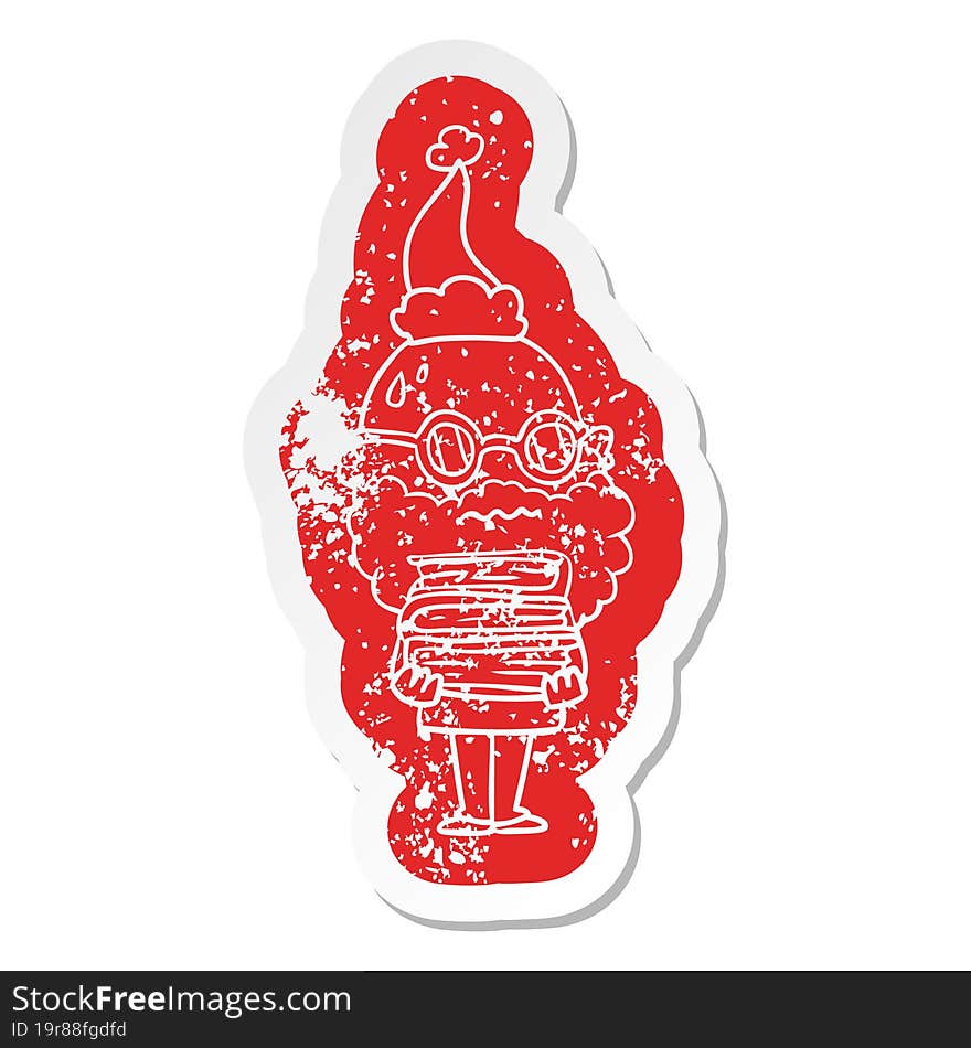 cartoon distressed sticker of a worried man with beard and stack of books wearing santa hat