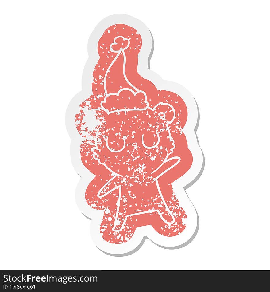 peaceful cartoon distressed sticker of a bear wearing santa hat