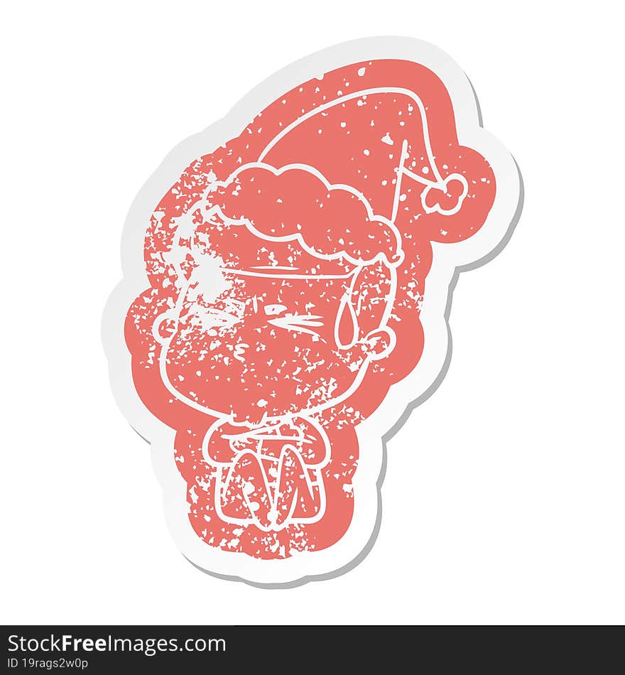 cartoon distressed sticker of a man sweating wearing santa hat