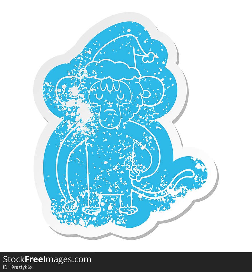 Cartoon Distressed Sticker Of A Monkey Scratching Wearing Santa Hat