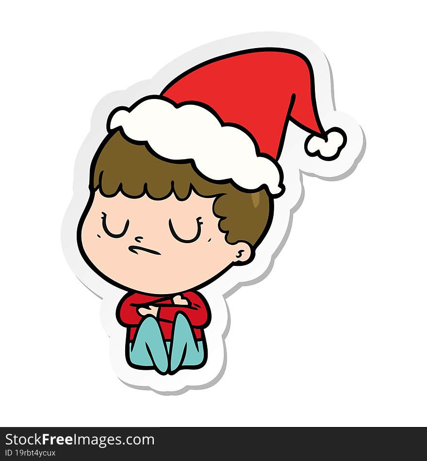 sticker cartoon of a grumpy boy wearing santa hat