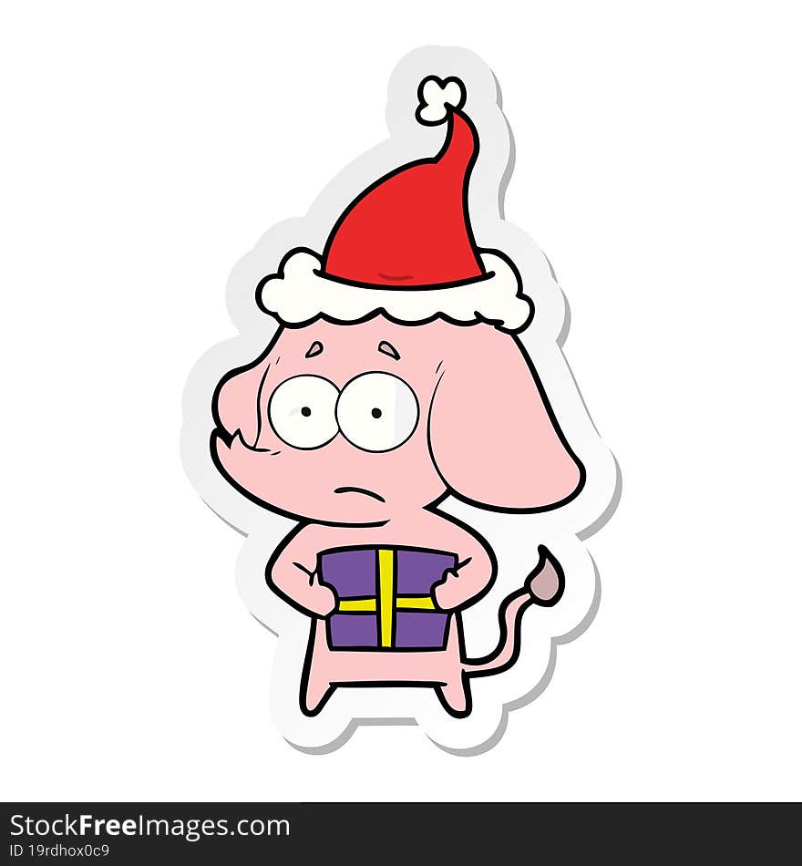 hand drawn sticker cartoon of a unsure elephant with christmas present wearing santa hat