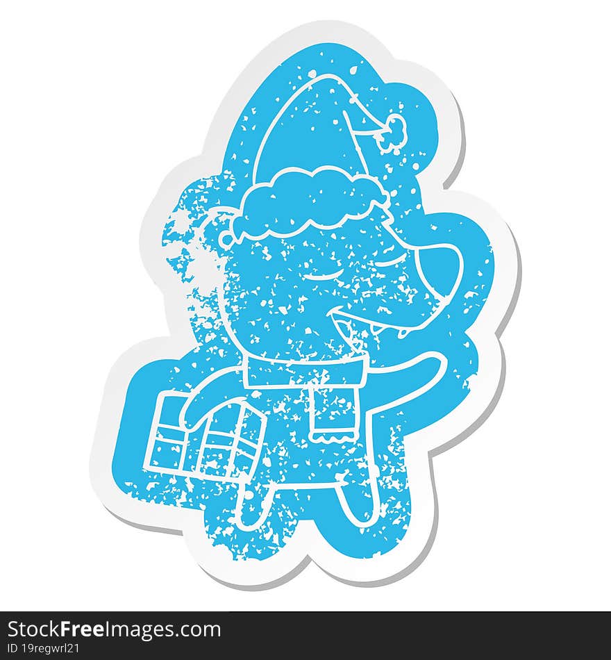 cartoon distressed sticker of a bear with present wearing santa hat