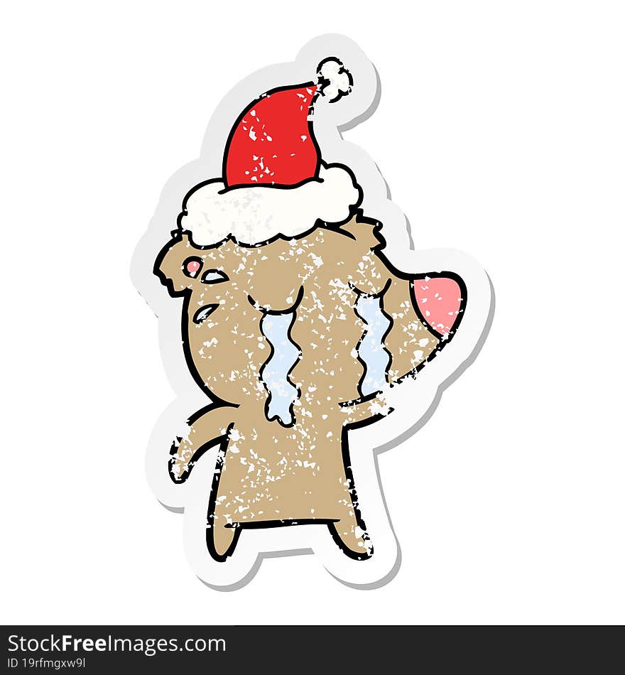 distressed sticker cartoon of a crying bear wearing santa hat