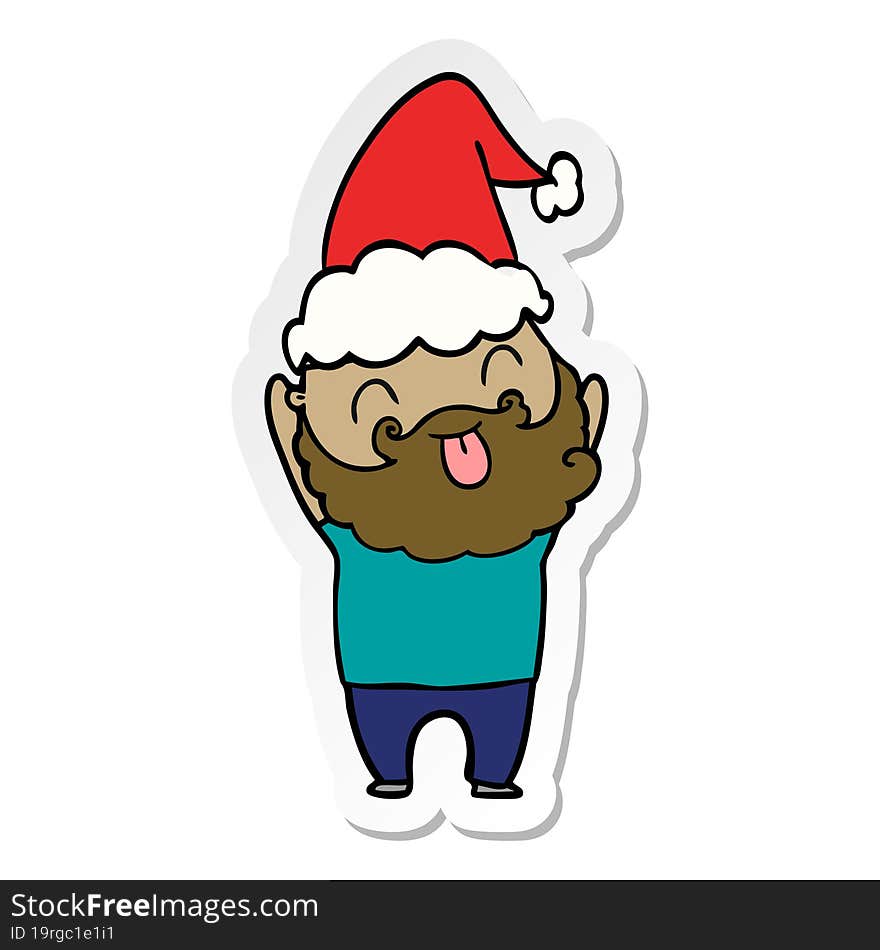 man with beard sticking out tongue wearing santa hat