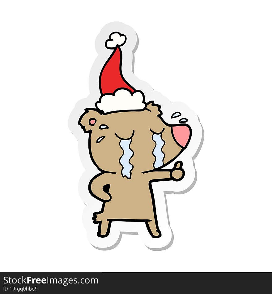 sticker cartoon of a crying bear wearing santa hat