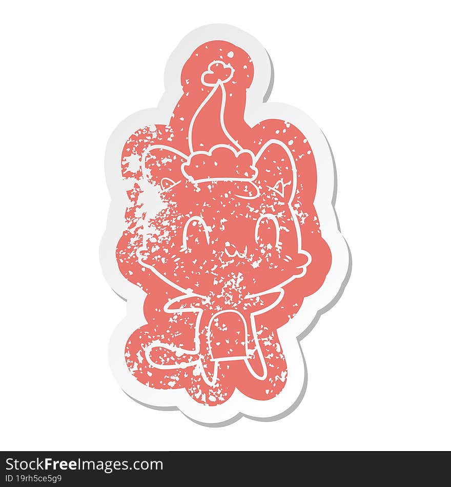 quirky cartoon distressed sticker of a happy cat wearing santa hat