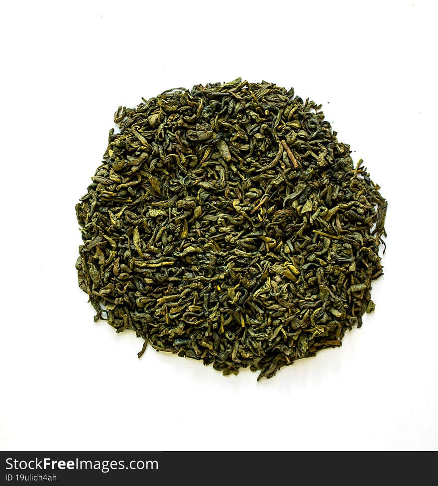 Dried green tea on a white background, close-up photo.