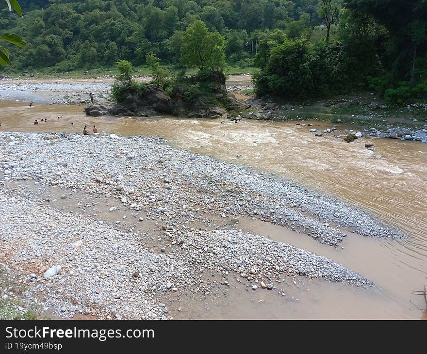 a stream with muddy water flowing after the rain fall