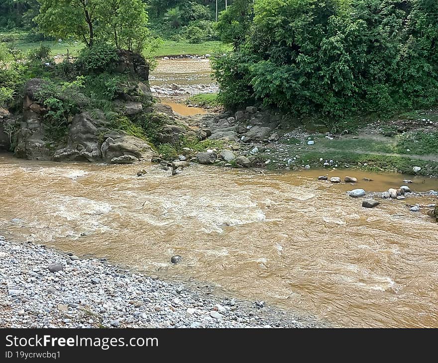 a rural landscape of a muddy stream after the rainfall