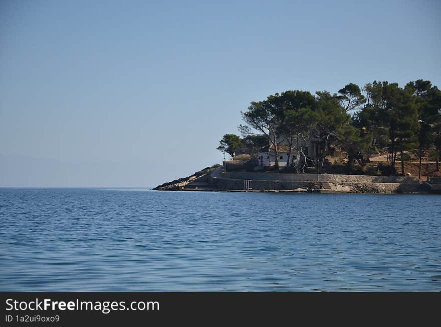 Island life and blue sea, lungomare and pine trees