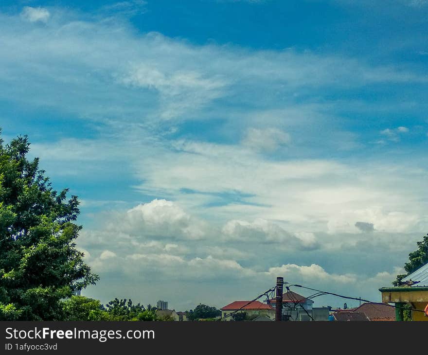 green natural scenery with beautiful and cool clouds that are pleasing to the eye