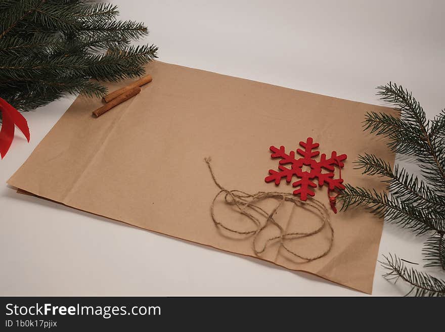 Christmas background with cinnamon, brown paper and fir branches