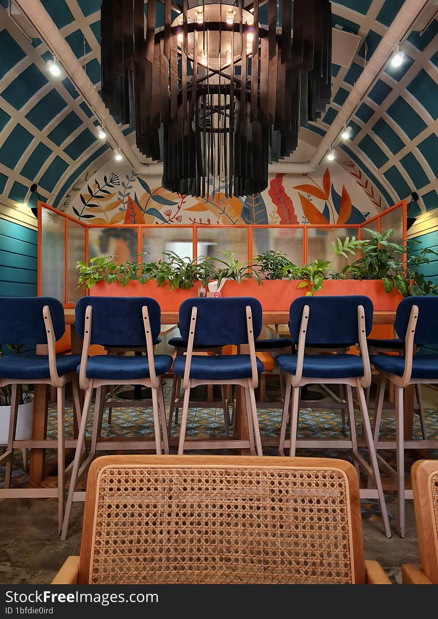 Different chairs in the bright hall of the restaurant