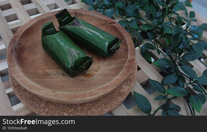 Kue lemper is a typical Indonesian food consisting mainly of sticky rice filled with chicken and rolled in banana leaves