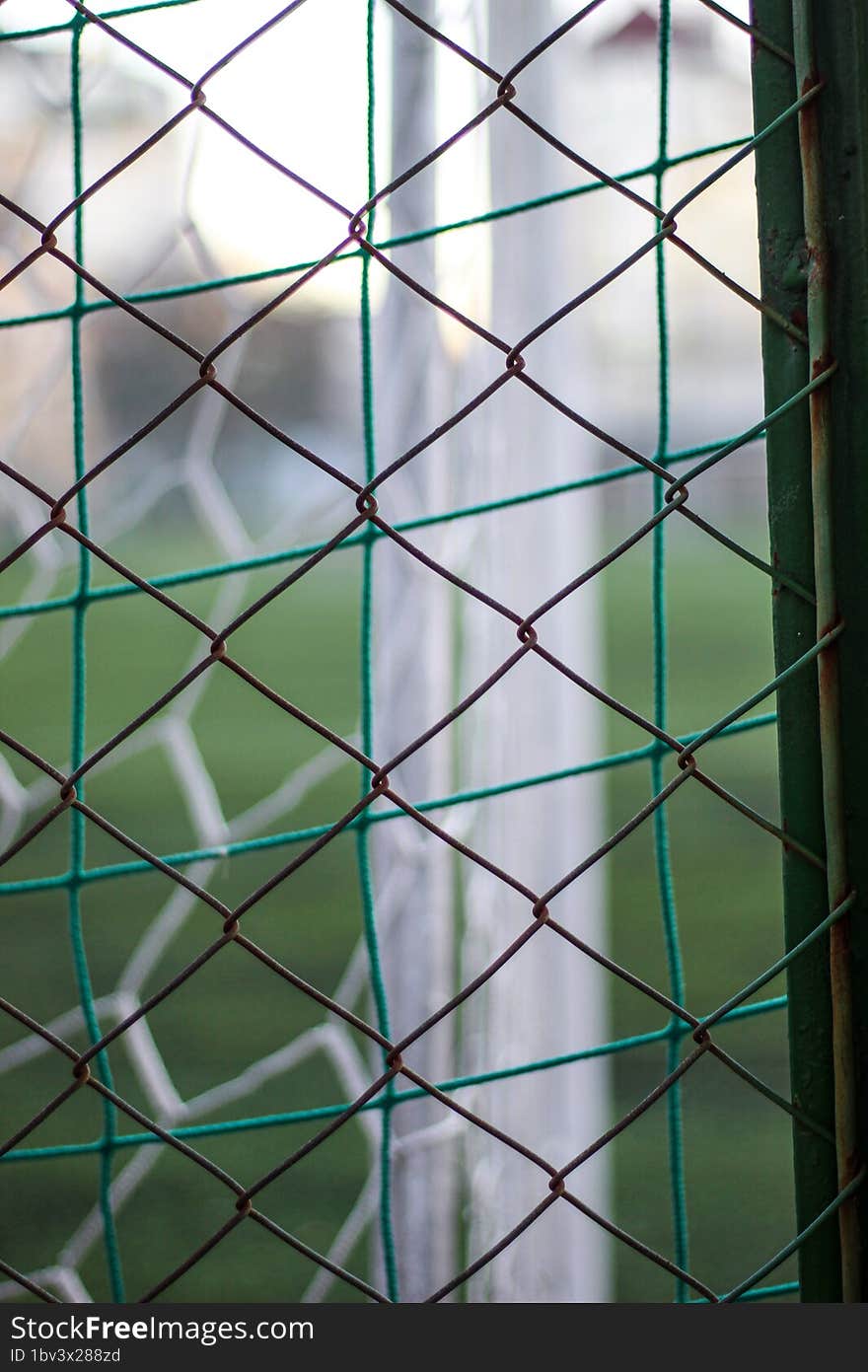 A Chain-link Fence On A Children& X27 S Football Field.