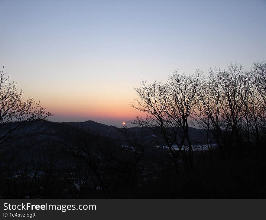 winter sunset mountains and sea