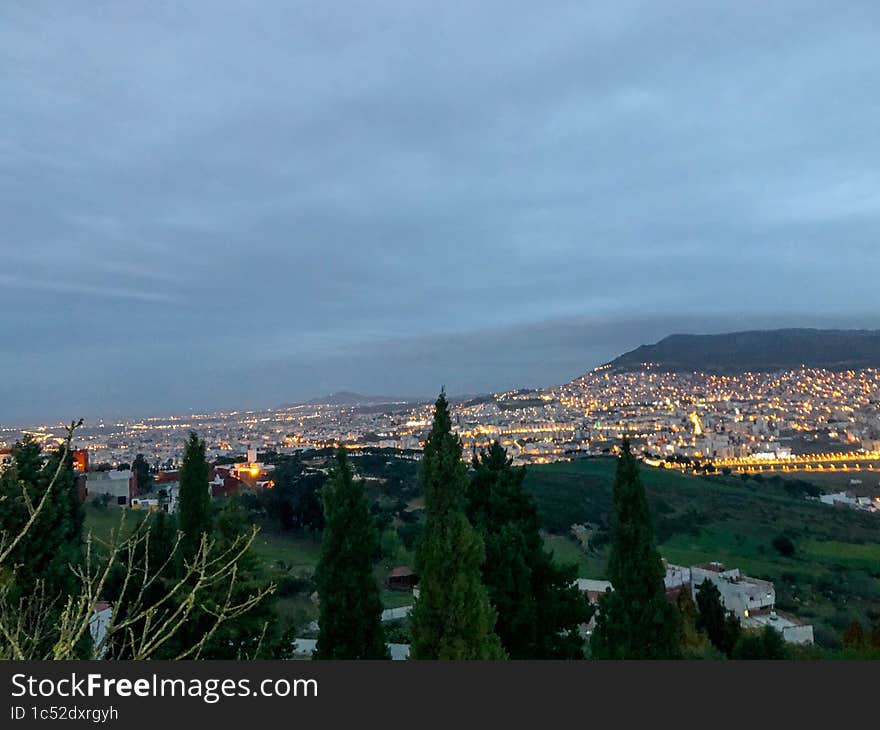 Breathtaking top view of the city shrouded in a mesmerizing and mystical foggy evening