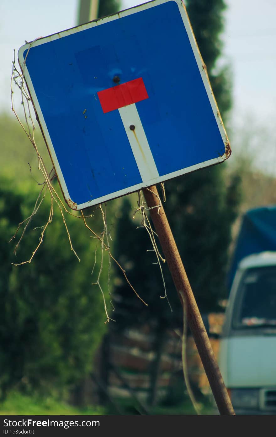 An Old Beveled Road Sign.  The Iconic Designation & X22 Dead End& X22 . Rural Road. An Old Truck In The Background.