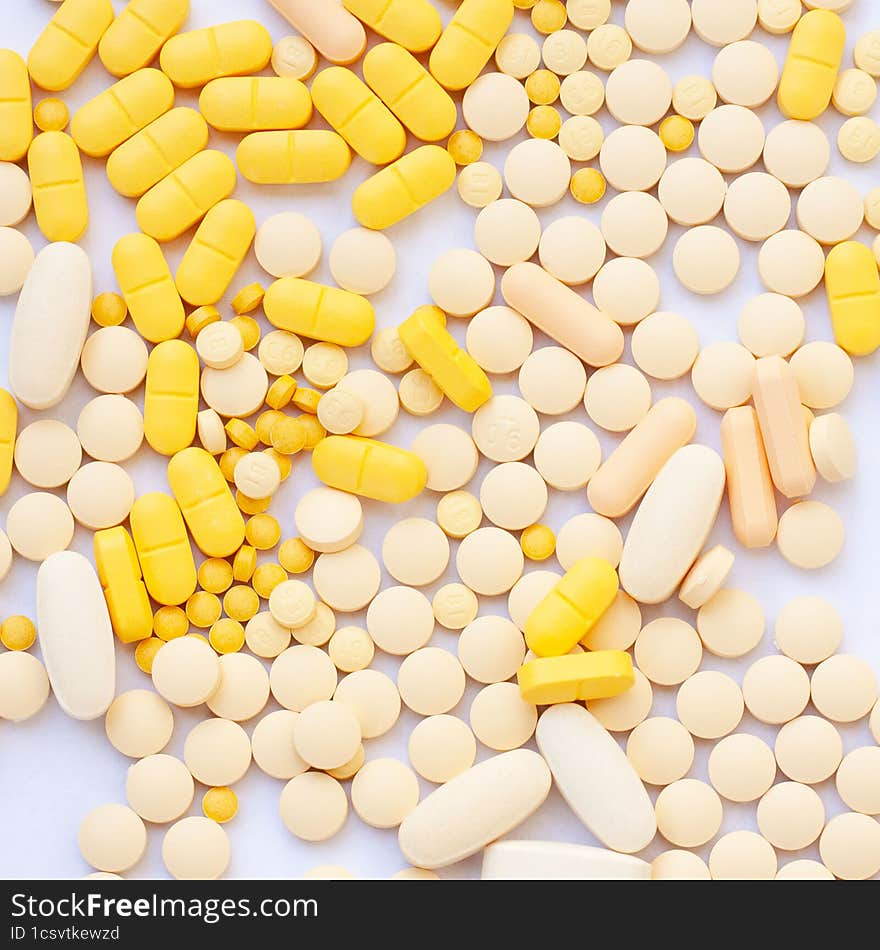 yellow pills on white background