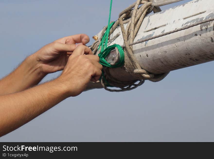 Hands with the green rope