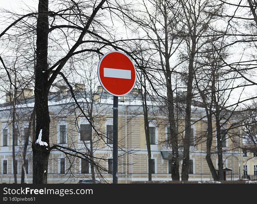 road sign meaning traffic is prohibited on the background of the building in winter