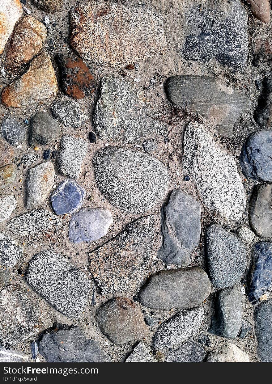 Dirt road. Rubble on the ground. Crushed stone of gray, brick, white and black colors