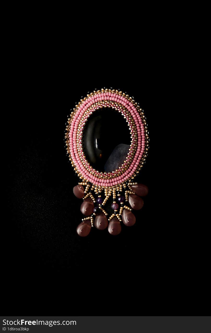 Women& x27 s brooch made of agate and decorated with beads