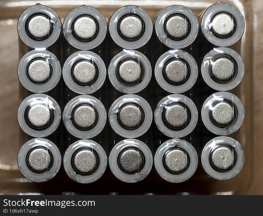 Galvanic cells, batteries are arranged in rows in the package. View from above. Background with batteries for shop, industry, busi