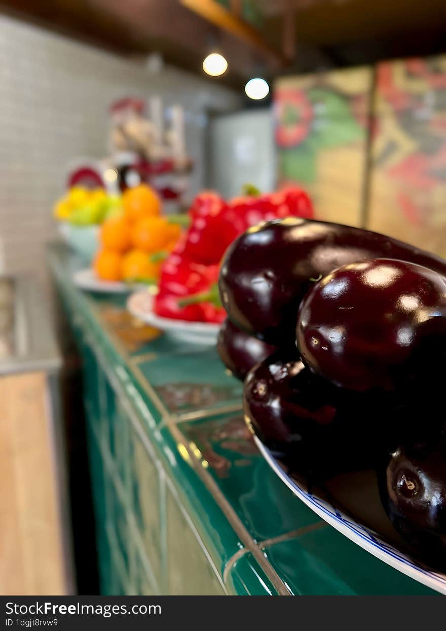 Dark purple eggplants in a plate