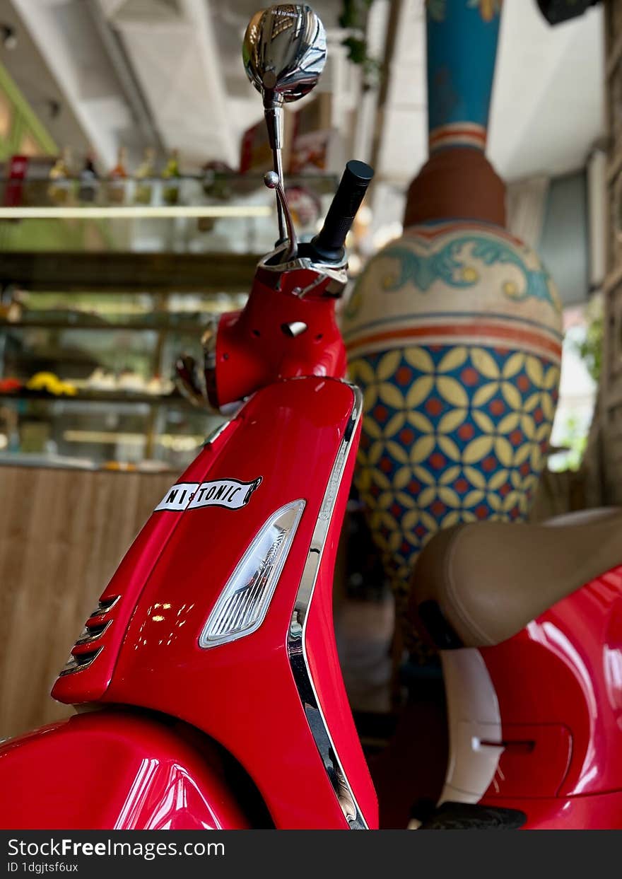 Shiny Red Moped In The Interior Of The Room