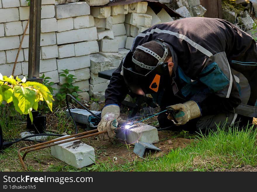 Man Doing Welding While Building His House