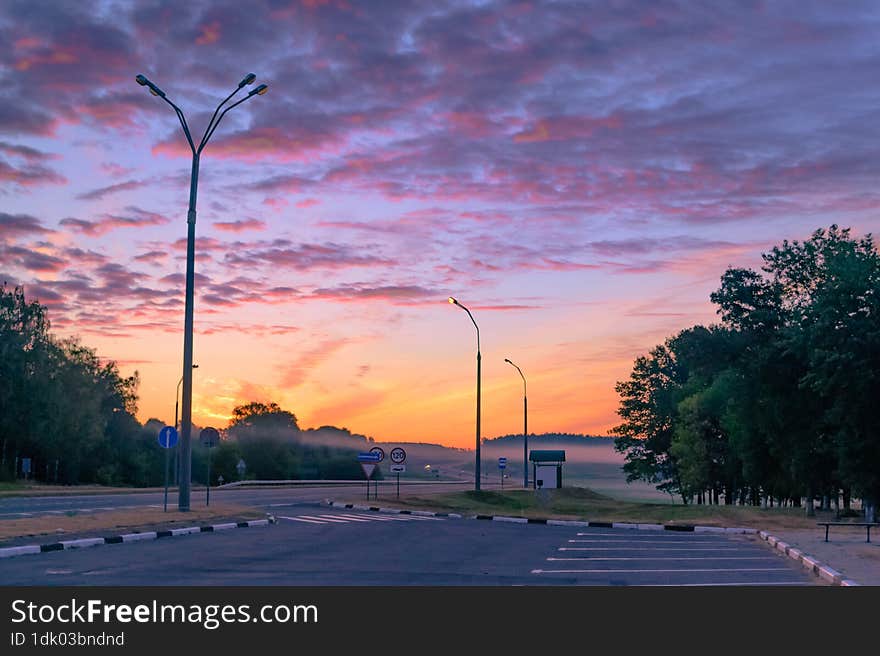 Purple dawn on the way, a resting place for travelers with a beautiful view of the sky and the road leading to an exciting new day