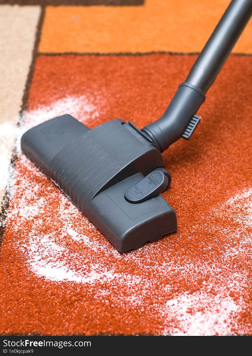 vacuum cleaner vacuums the carpet