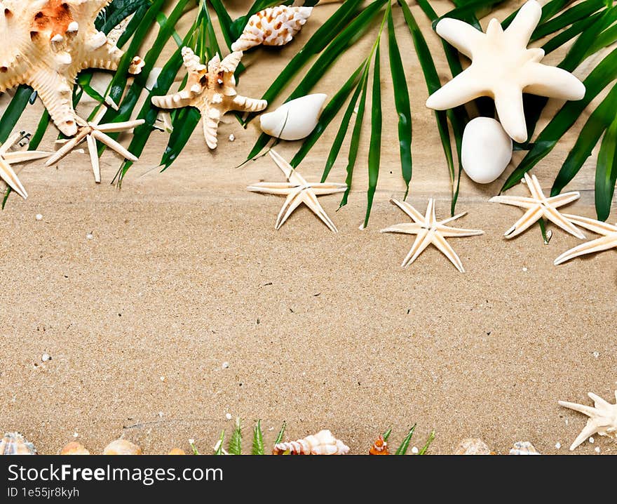 starfish and leaves on sand background decoration