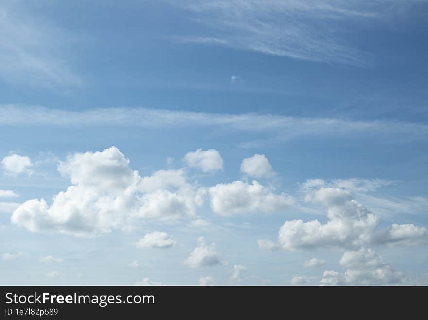 Low cumulus and wispy high clouds background.