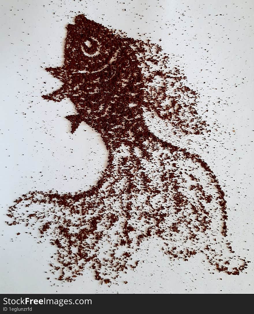 The Fish Is Golden. Coffee Powder Drawing On A White Background.