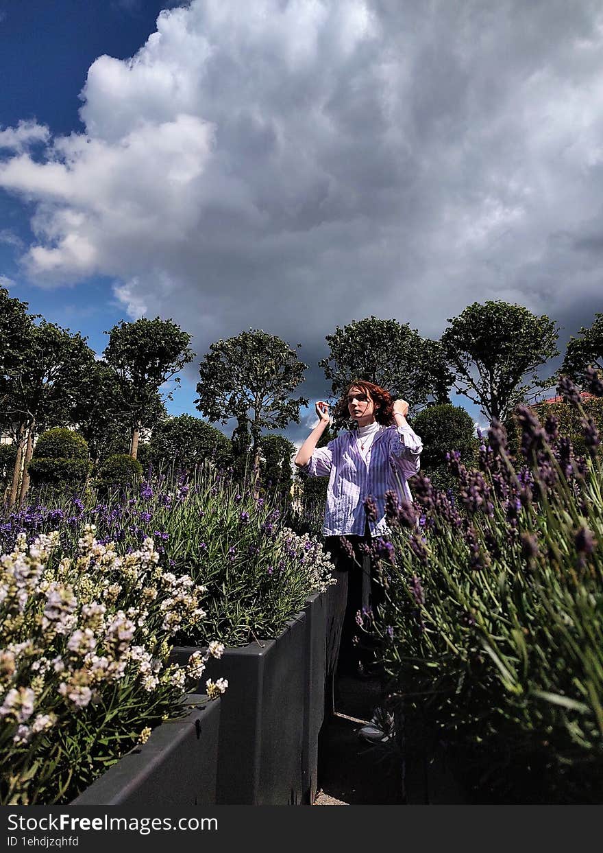 Girl among purple lavender bushes