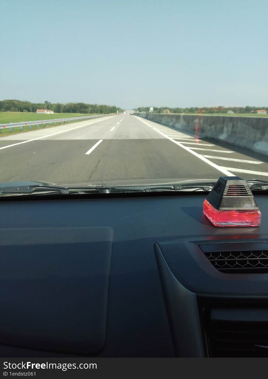 long journey by car on the highway with views of the blue sky